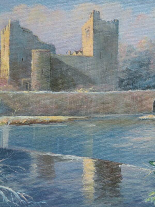 Cahir Castle stands majestically over a snowy river, framed by frosty trees and a hint of winter foliage in the foreground