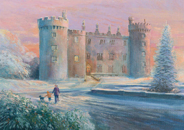 Snow-covered Kilkenny Castle at sunset, with a family walking their dogs along a path lined with frosty trees